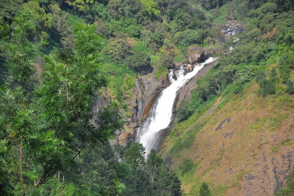 Stopping at Attukad, a famous waterfall in Kerala during travel.