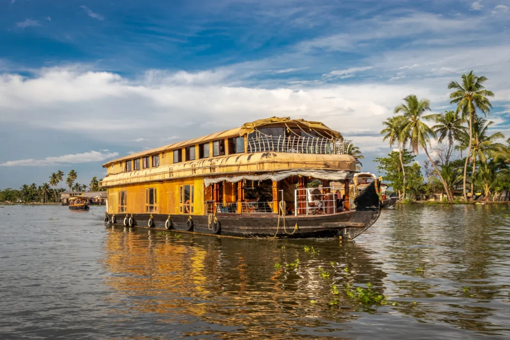 Cochin Munnar Thekkady houseboat tour drifting through calm backwaters.