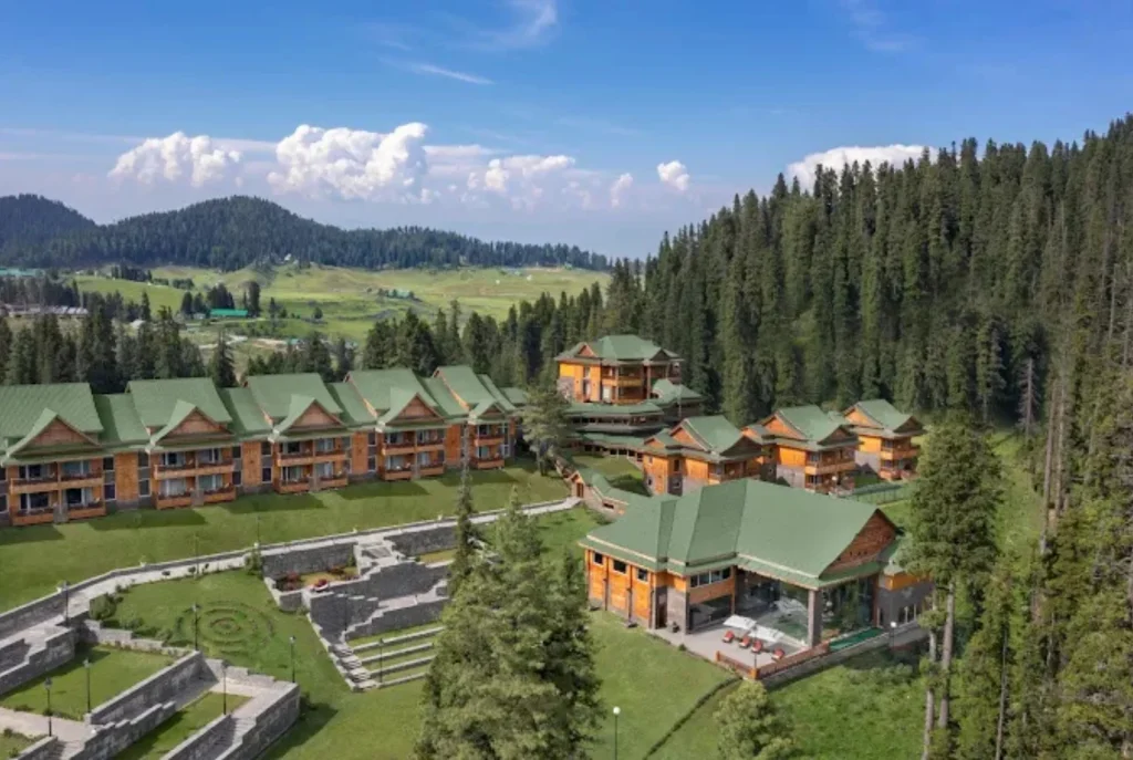 Snow covered mountains surrounding a peaceful nature luxury resort stay.